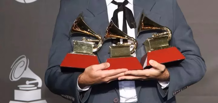 A 2019 Latin GRAMMY winner holds his three awards
