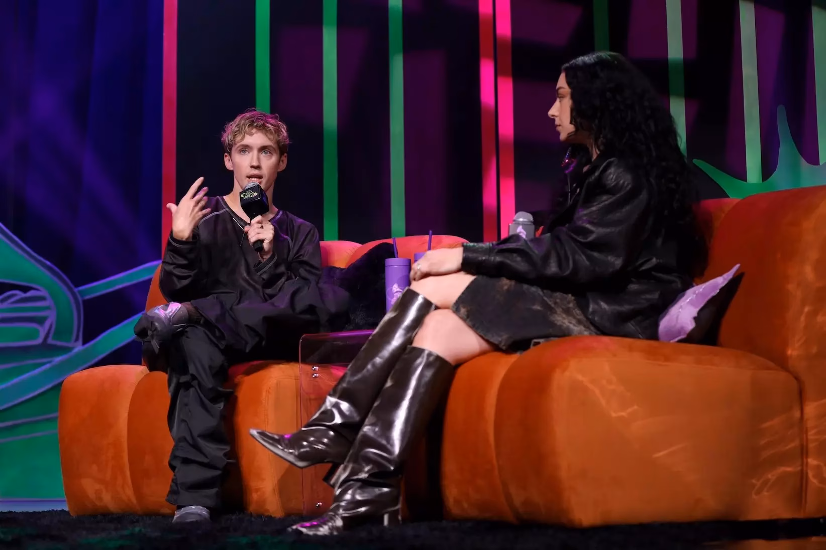Photo of Troye Sivan (L) and Charli XCX (R) speaking at the 2024 GRAMMY U Fall Summit