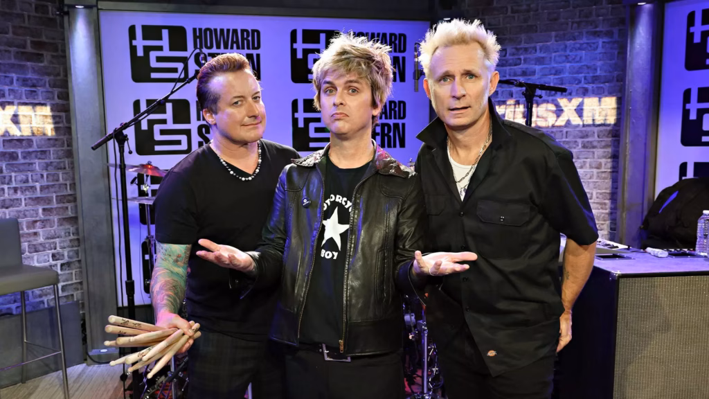 Green Day poses for a photo during an appearance on the Howard Stern show in Jan. 2024.