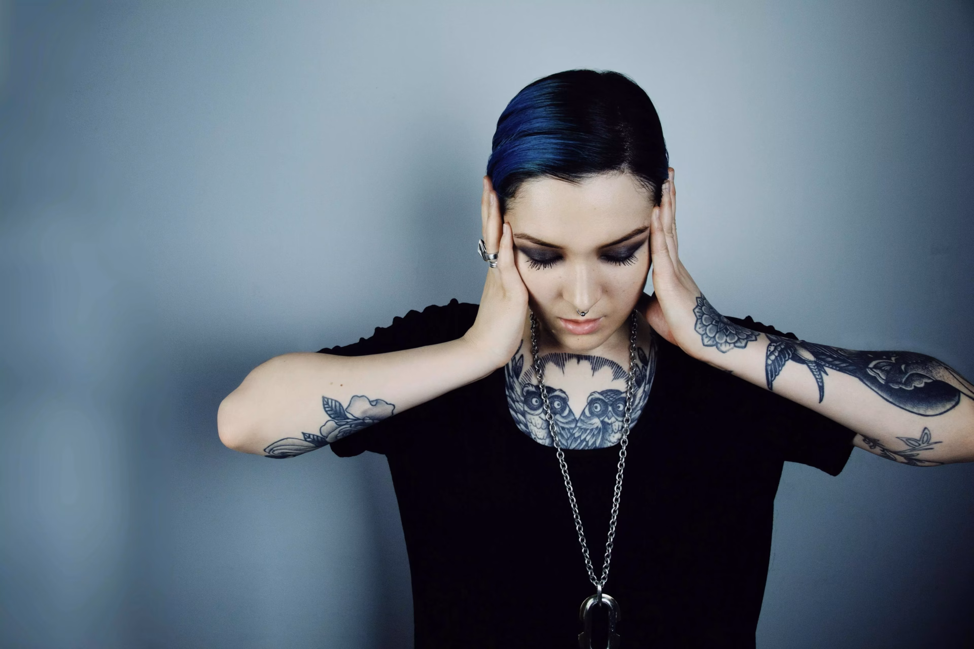 Maya Jane Coles poses with hands on face