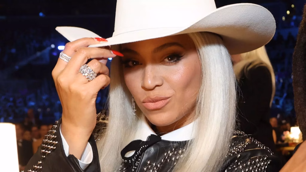 Beyonce tips her white cowboy hat to the camera at the 2024 GRAMMYs