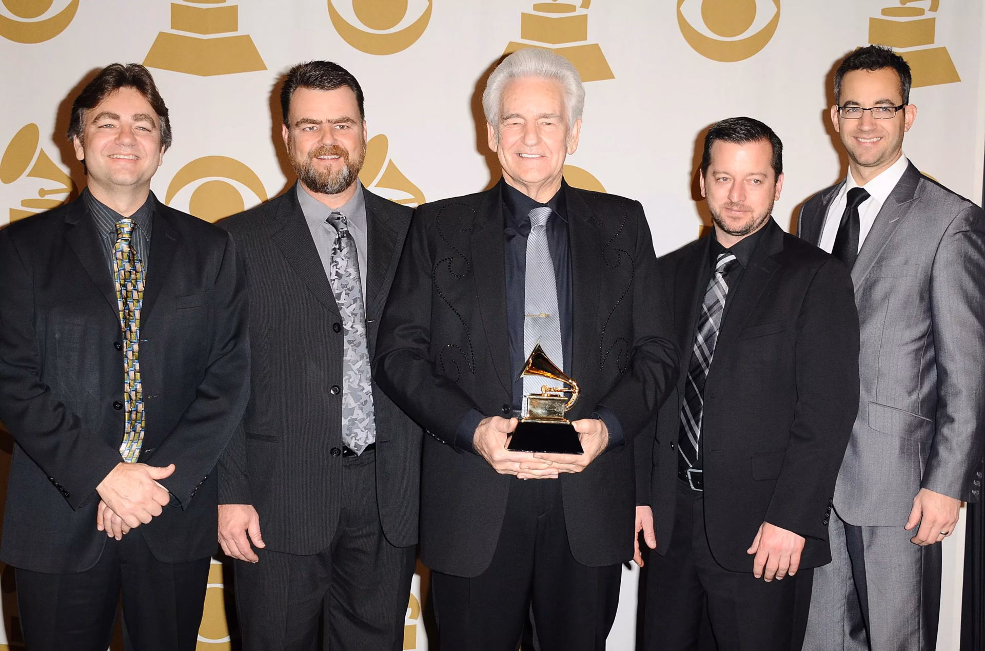 Del McCoury Band holding GRAMMY Award