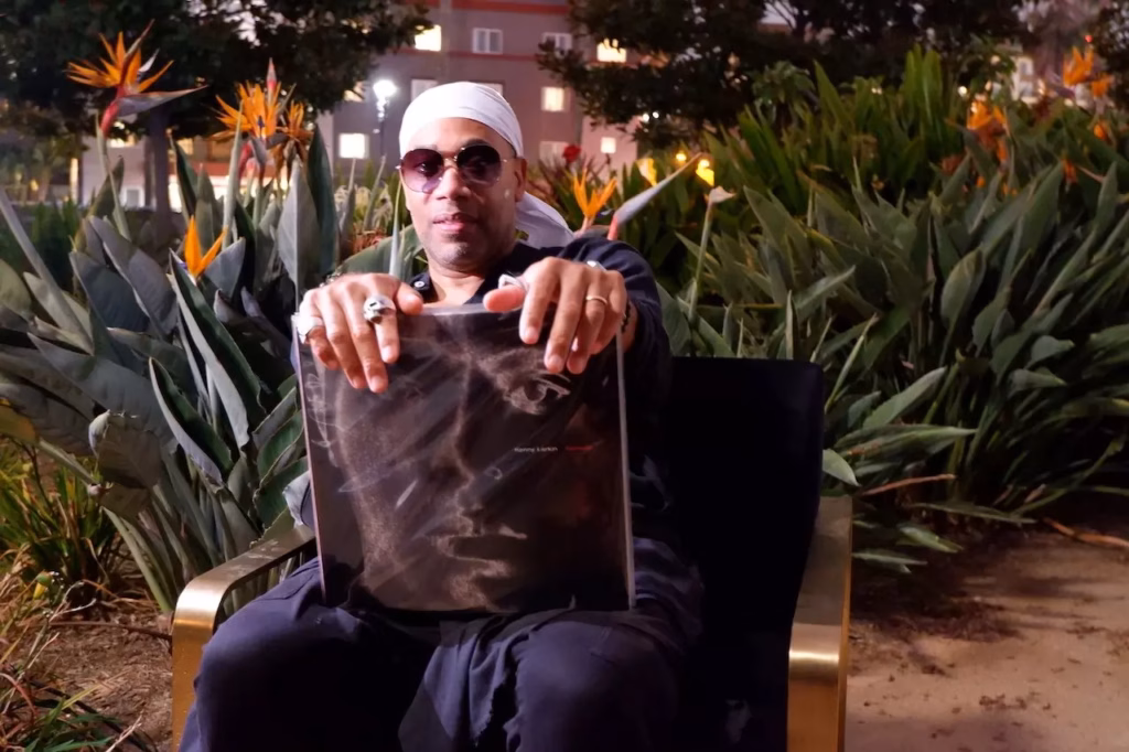 Carl Craig holds up vinyl selection