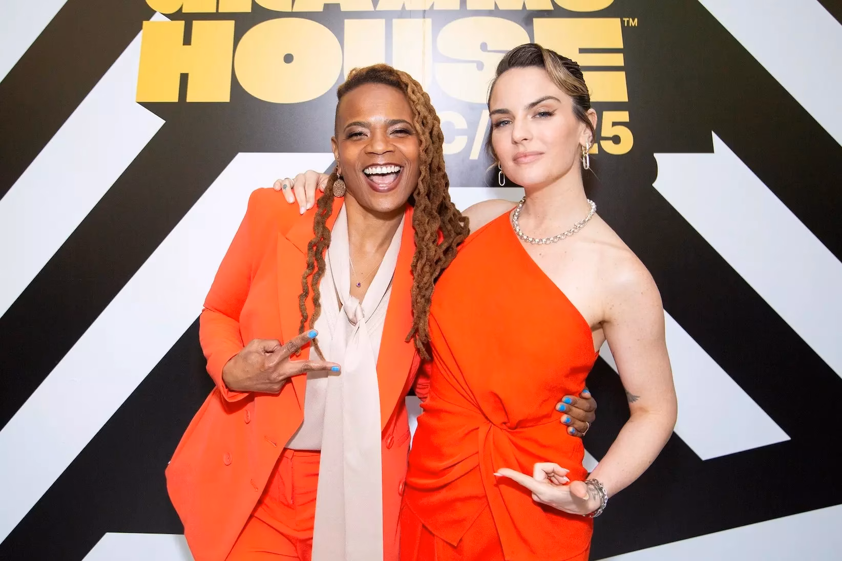 Divinity Roxx (L) and JoJo (R) attend the "Women Shaping the Future of Music" panel, presented by the Recording Academy's Women In The Mix, at GRAMMY House NYC on June 13, 2025, in NYC. Divinity Roxx and JoJo stand in front of the GRAMMY House NYC logo.