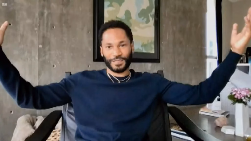 KAYTRANADA raises arms in surprise as he accepts his second GRAMMY