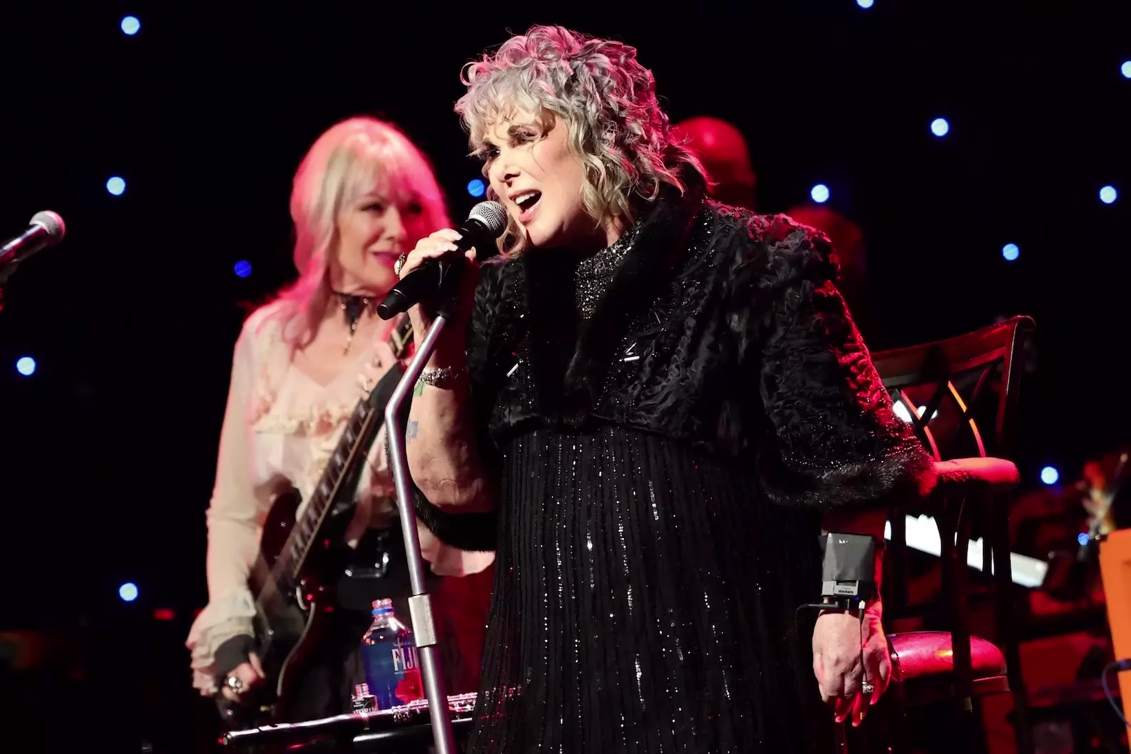 (L-R) Nancy Wilson and Ann Wilson of Heart perform onstage during the 2026 Grammy Hall of Fame Gala on Friday, May 8, 2026, at The Beverly Hilton in Los Angeles. Nancy Wilson is holding a guitar and Ann Wilson is singing into a microphone.