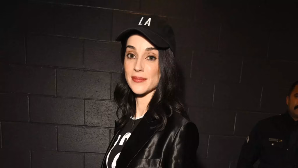 St. Vincent wears a black baseball hat that reads 