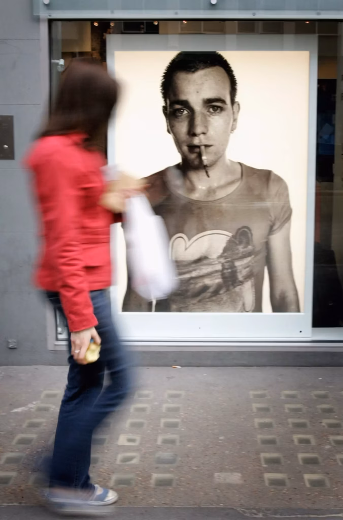 A girl looks at a photograph of Ewan McGregor who played Renton in the film 'Trainspotting' before the Private view for ?Look At Me - A Retrospective?